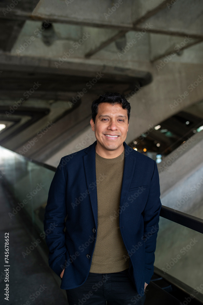Smiling businessman with hands in pocket standing near railing Smiling businessman with hands in pocket standing near railing