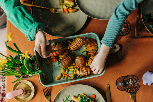Family having freshly baked potatoes at Easter dinner