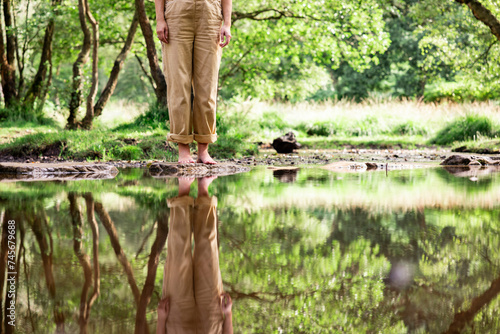 Woman standing on rock in river photo
