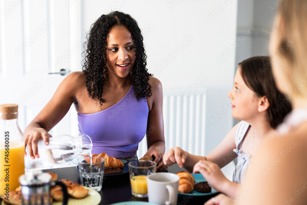 Mother and daughter having breakfast and talking at home Mother and daughter having breakfast and talking at home