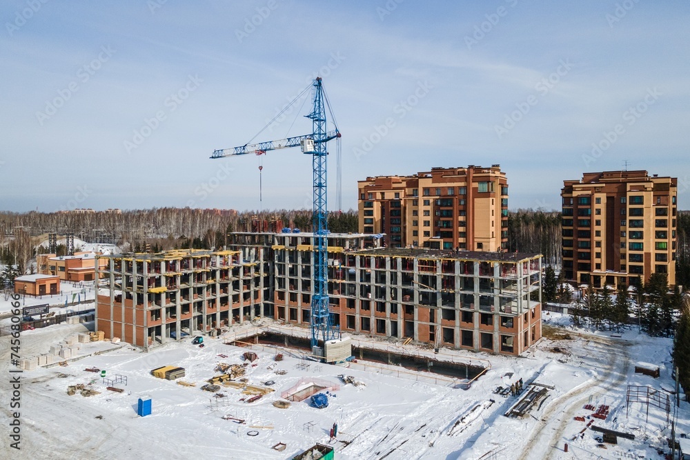 the construction site of an apartment building in the winter from a height