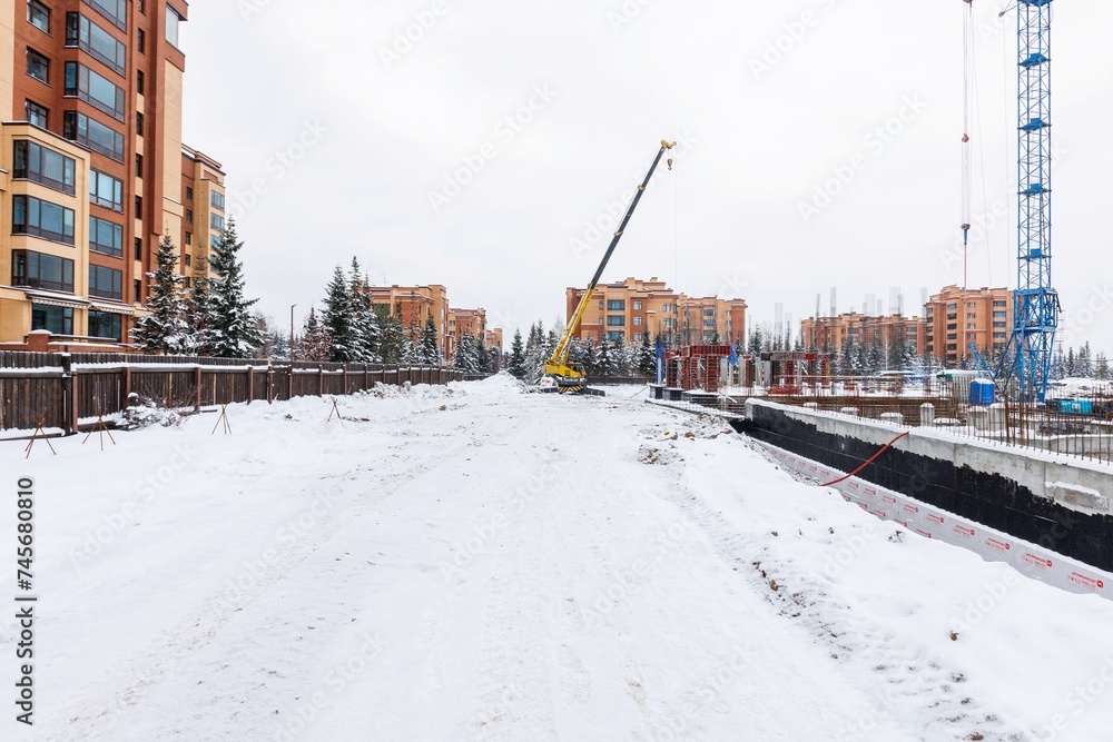 the construction site of an apartment building in the winter from a height