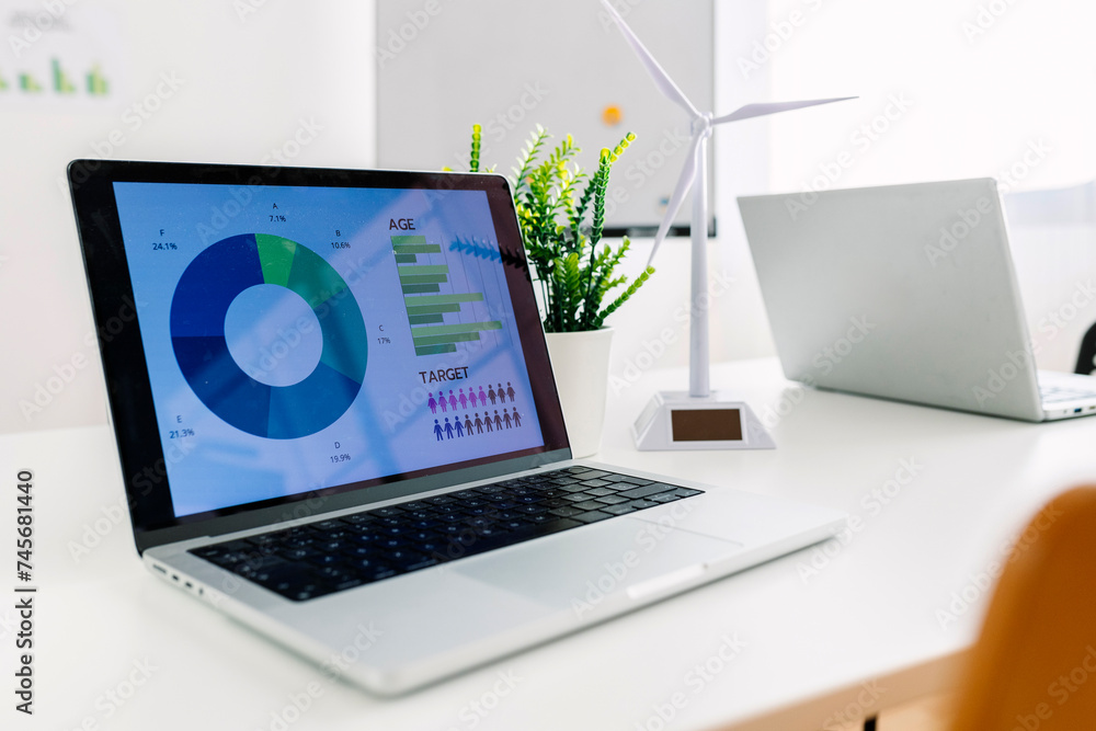 © Westend61 - Laptop with charts and graphs on screen near wind turbine model at office © Westend61 - Laptop with charts and graphs on screen near wind turbine model at office