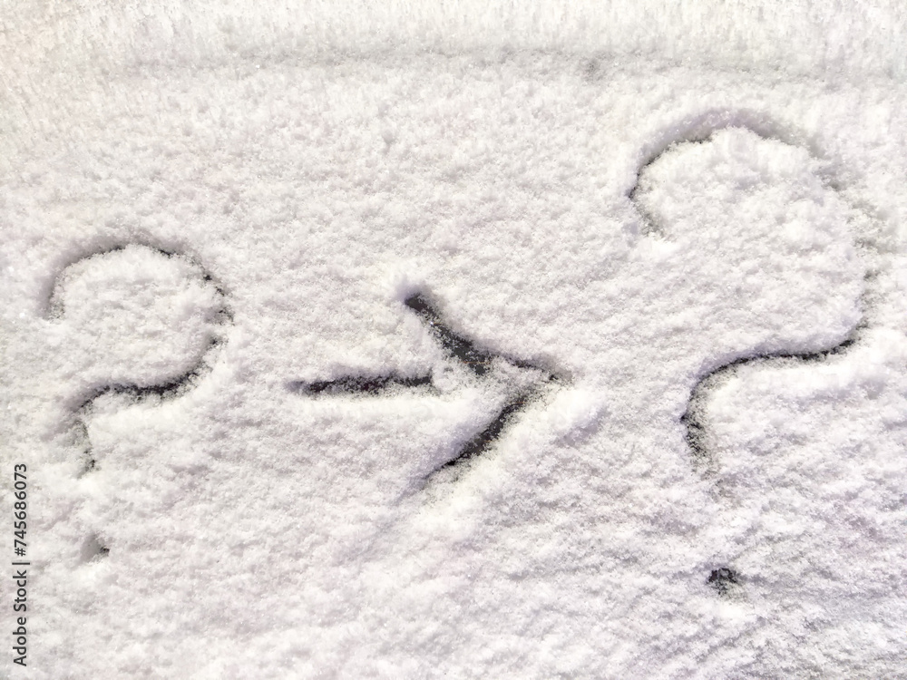 Two question marks and arrow written in the snow. The cold frosty texture of the snow and the question mark. Background, place for text, copy space Two question marks and arrow written in the snow. The cold frosty texture of the snow and the question mark. Background, place for text, copy space