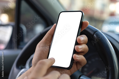 Man hand hold phone with isolated screen steering wheel car