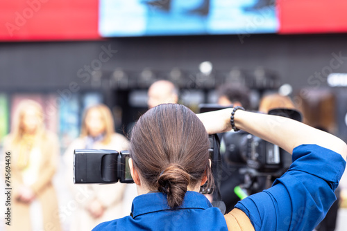 Photos Female photographer photographing press conference, media or news event