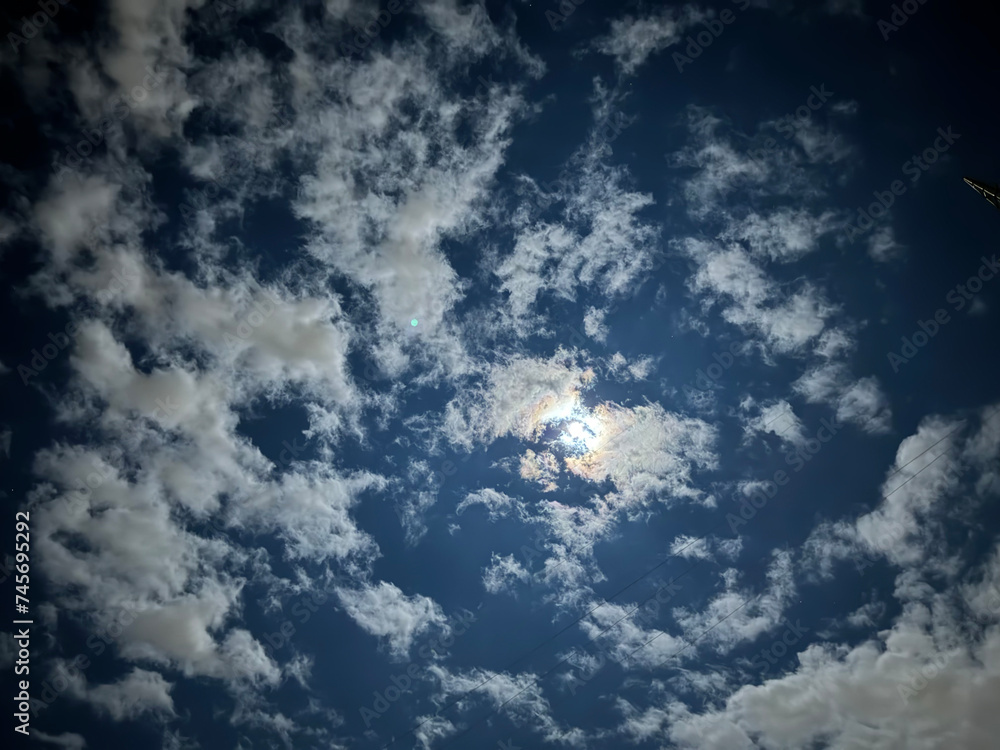 Cloudy sky at night with a shining moon. Cloudy sky at night with a shining moon.
