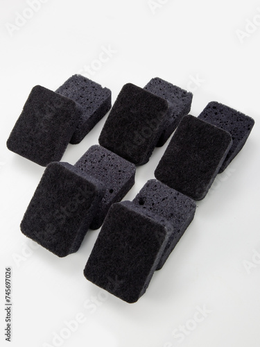 set of black sponges for washing dishes on a white background