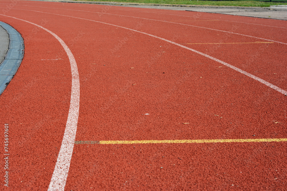 Red running track in stadium as a concept sport life. Red running track in stadium as a concept sport life.