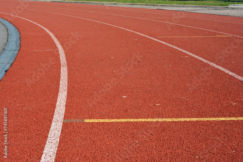 Red running track in stadium as a concept sport life.