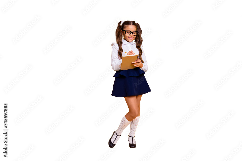 Full length, legs, body, size portrait of carefree, careless, beautiful, pretty, charming, lovely small girl isolated on shine yellow background write essay in diary, textbook Full length, legs, body, size portrait of carefree, careless, beautiful, pretty, charming, lovely small girl isolated on shine yellow background write essay in diary, textbook