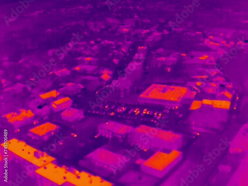 Aerial infrared thermal view of residential area with residential buildings and houses, in purple and yellow hues
 photo