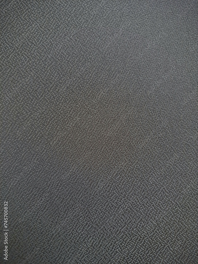 Abstract textured gray background from rough fabric. The background is behind. Abstract textured gray background from rough fabric. The background is behind.