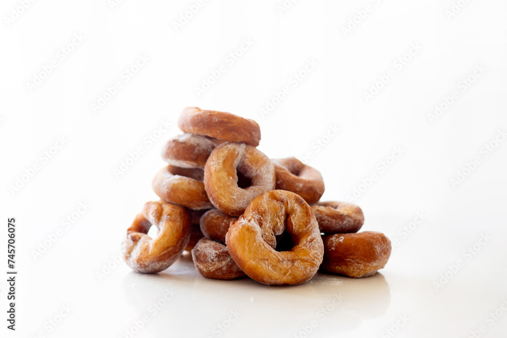 Cute school child, boy, eating doughnuts at home, homemade fresh donuts with sugar Cute school child, boy, eating doughnuts at home, homemade fresh donuts with sugar