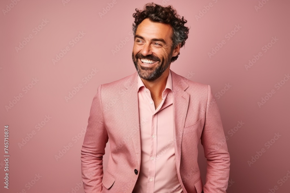 Handsome middle aged man in a pink suit posing on a pink background. Handsome middle aged man in a pink suit posing on a pink background.