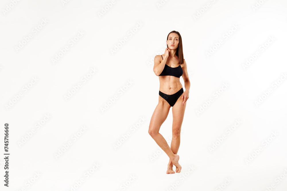 Full length portrait of beautiful sporty sensual woman black underwear on white studio background Full length portrait of beautiful sporty sensual woman black underwear on white studio background