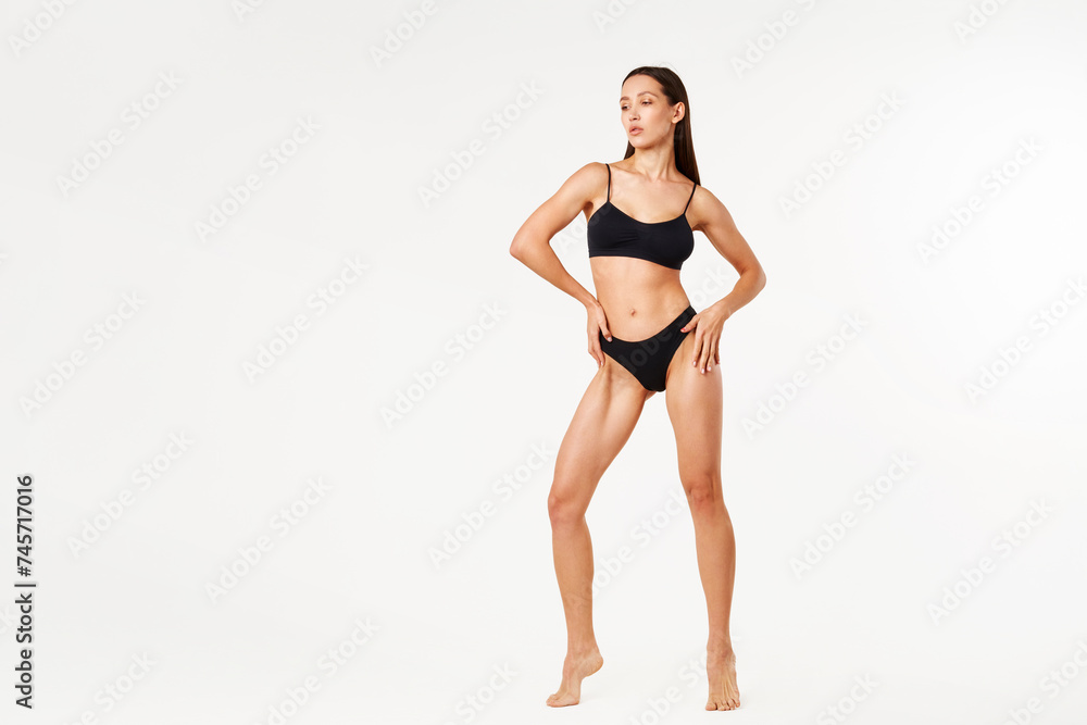 Full length portrait of beautiful sporty sensual woman black underwear on white studio background Full length portrait of beautiful sporty sensual woman black underwear on white studio background
