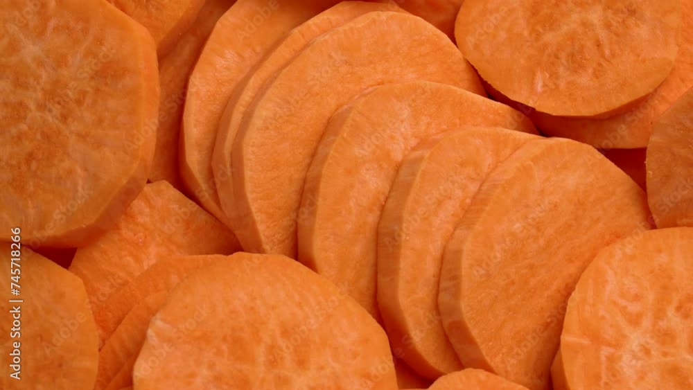 Sliced sweet potato. Fresh vegetable ingredients close up. Rotation Sliced sweet potato. Fresh vegetable ingredients close up. Rotation