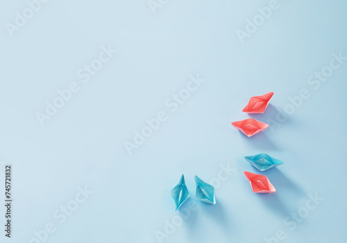 pink and blue paper boats on blue background, concept of various relationships