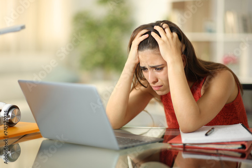 Bilde på lerret Sad student checking laptop trying to learn at home
