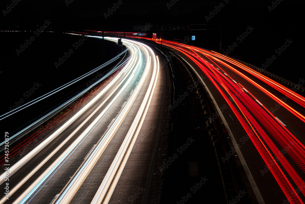 Light trails on the highway at night. Rush hour on motorway with glowing cars headlamps, long exposure Light trails on the highway at night. Rush hour on motorway with glowing cars headlamps, long exposure