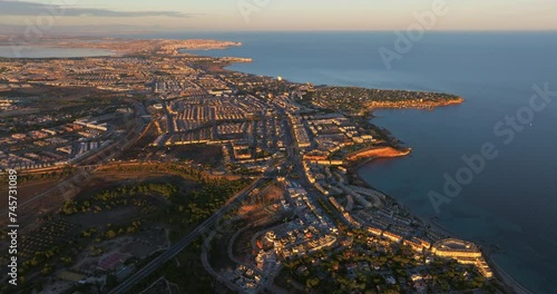 Aerial view of the beaches and coves of Cabo Roig at sunset, Alicante province, Spain photo