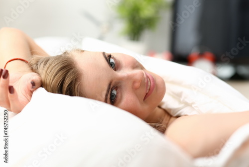 Young beautiful woman waking up in the morning