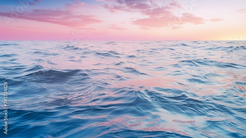 Full frame background of blue sea water rippling and reflecting pink sundown light