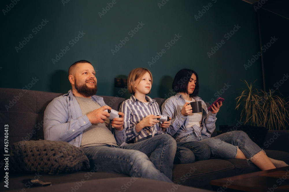 Family spends weekend in the house playing video games Family spends weekend in the house playing video games