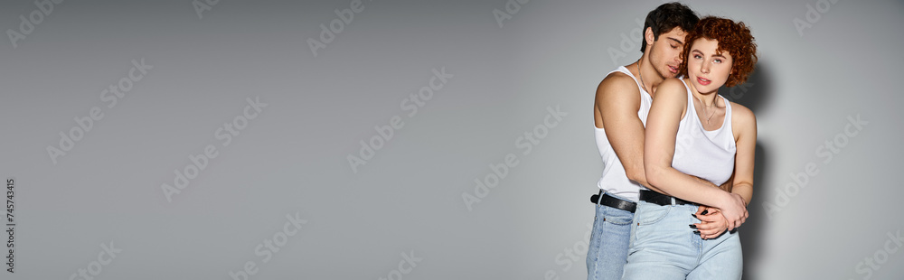 handsome man hugging his beautiful girlfriend while she looking at camera, sexy couple, banner handsome man hugging his beautiful girlfriend while she looking at camera, sexy couple, banner