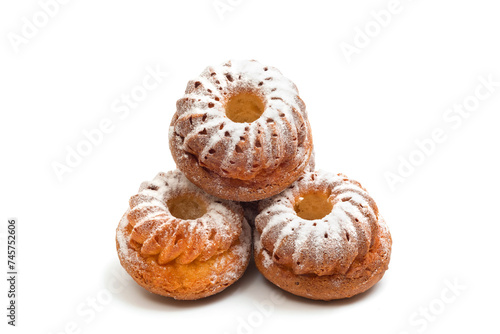 Muffins with powdered sugar isolated on white background. Homemade baked goods close-up