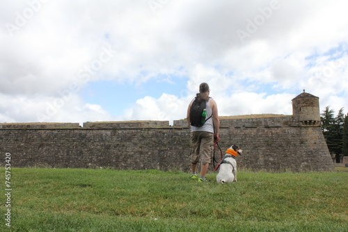 Owner with her dog observing the castle.