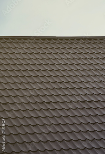 The texture of the roof of painted metal. Close-up detailed view of roof covering for pitched roof. High quality roofing © mehaniq41