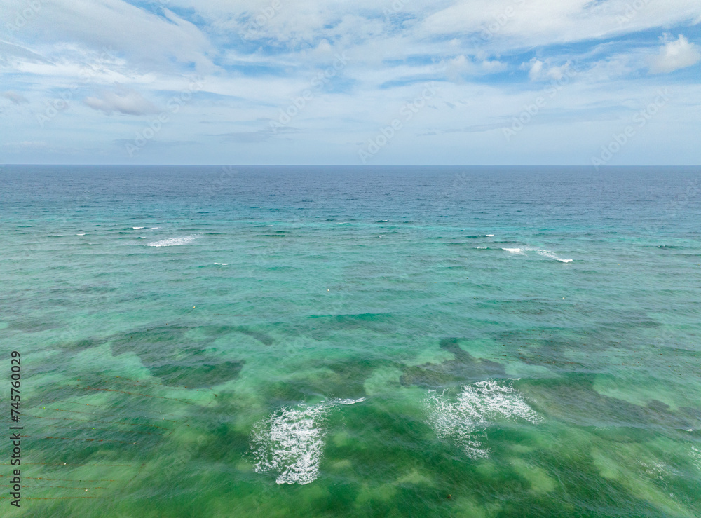 Ocean waves and corals reefs with turquoise water. Blue sea in Santa Fe, Tablas, Romblon. Philippines.