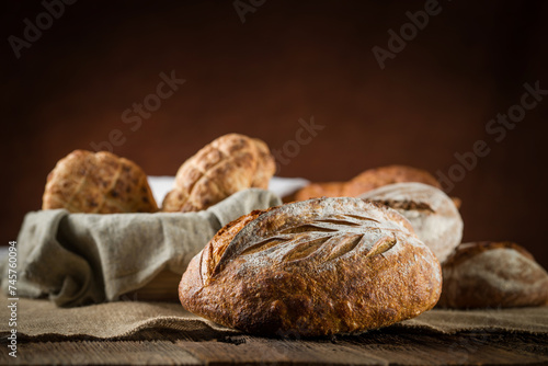 Close up of rustic artisan sourdough bread on wooden background