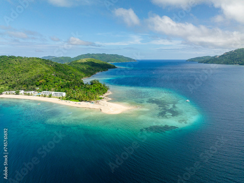 Beach with boats on white sand in Logbon Island. Romblon, Philippines.