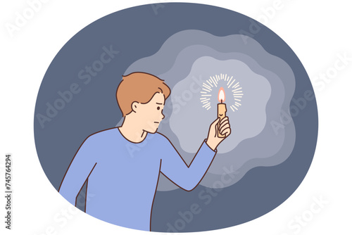 Intrigued man carries burning candle, illuminating path in darkness, hearing rustle or sound