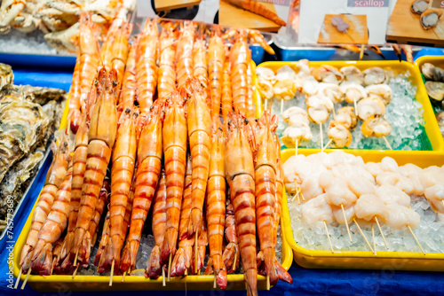 Fresh seafood selling at Kuromon Ichiba in Osaka Japan. The Kuromon Ichiba is a spacious market with vendors selling street food, fresh produce and shellfish, plus souvenirs, Seafood in Kuromon Market photo