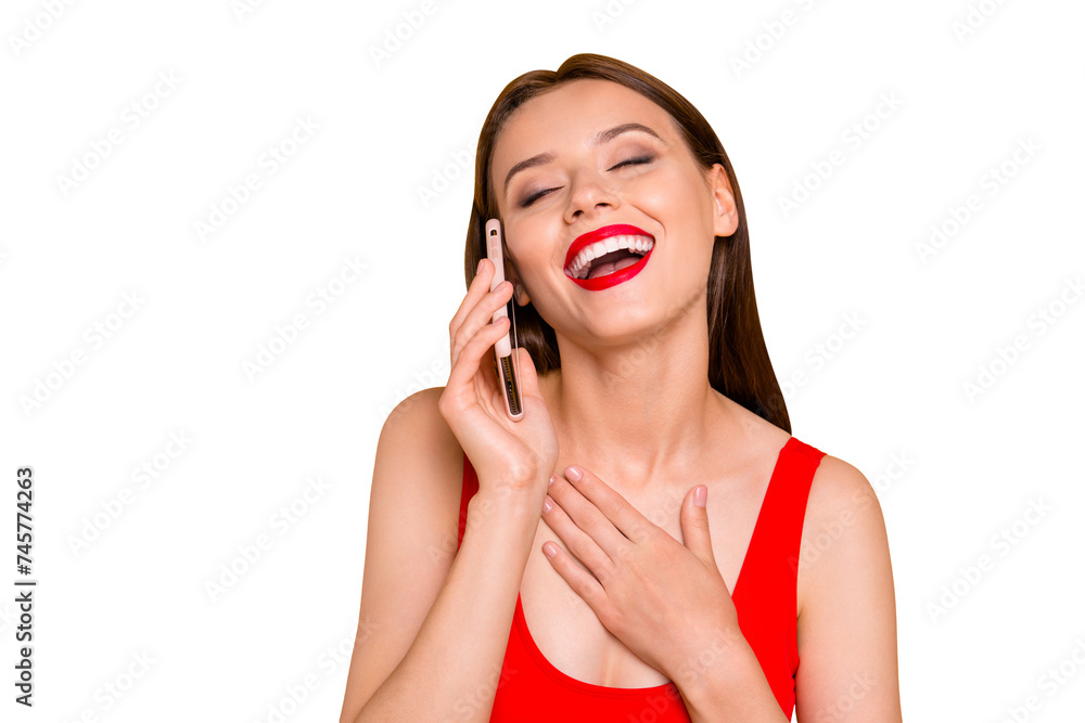 Close up portrait of trendy young woman laughing while talking on the cellular  isolated on yellow background