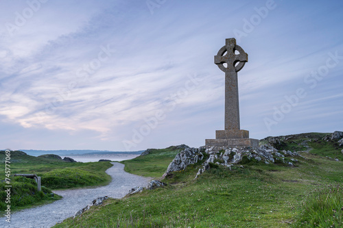 A Celtic cross on Llanddwyn, along the coast of Anglesey, Wales, near Newborough Beach. It is sunset photo