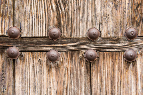Metal and wood details of an old door in a town in Spain