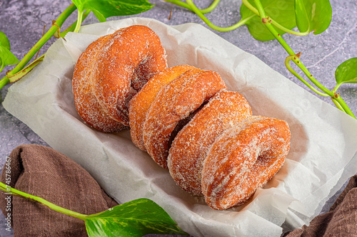 Gourmet Treats: Donuts in Parafin-Lined Box on Dark Marble photo