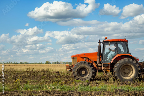 an agricultural tractor driving in the field