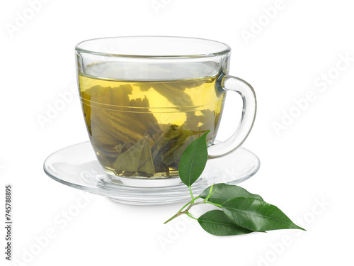 Fresh green tea in glass cup, leaves and saucer isolated on white