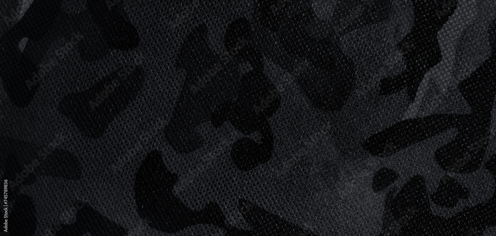 Naklejka premium Texture of camouflage fabric as background, black and white effect. Banner design