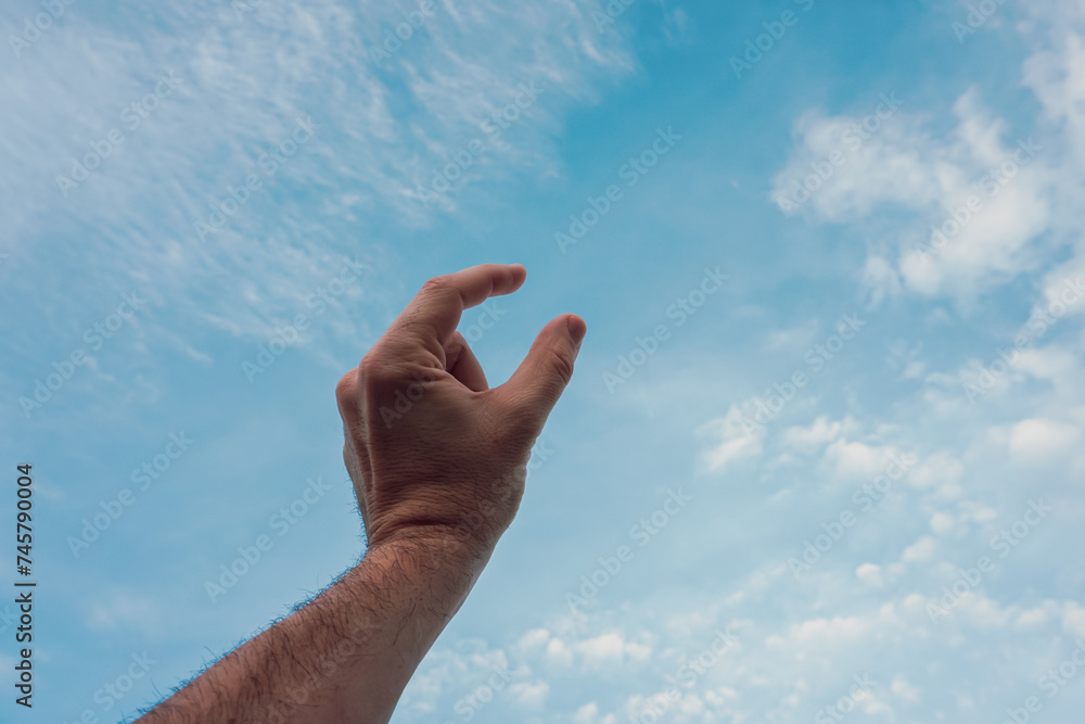 man hand gesturing on the blue sky man hand gesturing on the blue sky