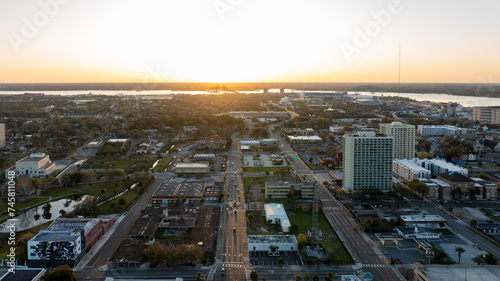Sunrise view over Jacksonville, Florida, with urban streets leading towards the horizon.
