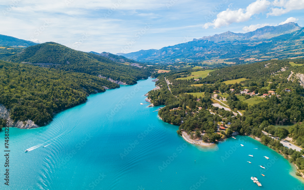 Fototapeta premium Aerial photo by drone of the Chanteloube bridge drowned in the turquoise waters of the Serre-Ponçon lake, located in the Hautes-Alpes, in France