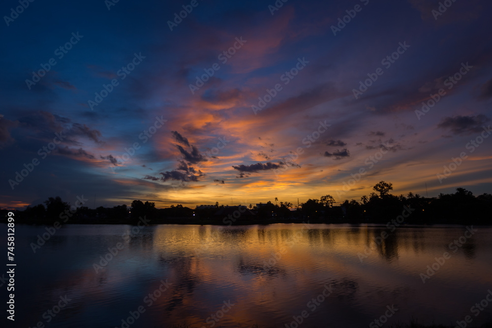 Nature silhouette twilight sky on lagoon with light reflectio