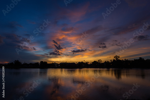 Nature silhouette twilight sky on lagoon with light reflectio photo